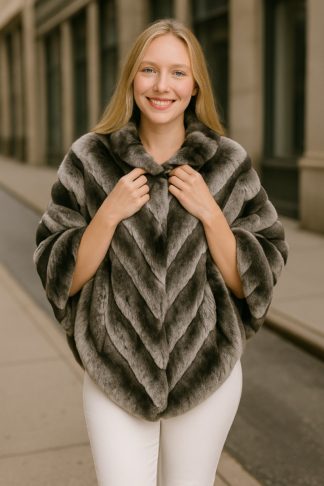 Chinchilla fur poncho with chevron pattern, short sleeves, and stand collar, worn outdoors.