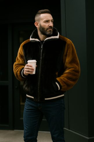 Whiskey and ranch mink bomber jacket with striped rib-knit collar, cuffs, and hem.