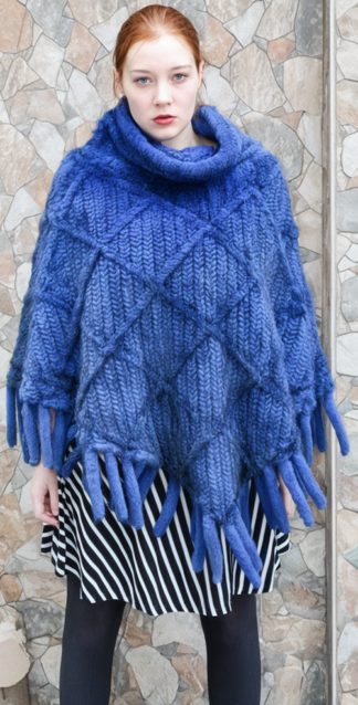 Cobalt blue knit mink poncho with a cowl collar and fringe-trimmed hem.