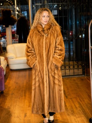 Full-length whiskey mink directional coat with a stand collar and button closure, worn by a model.
