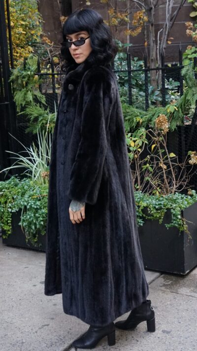 Full-length blackglama mink coat with a classic collar, straight sleeves, and front button closure.