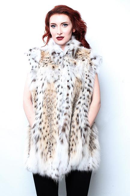 A woman with red hair wearing a fur jacket