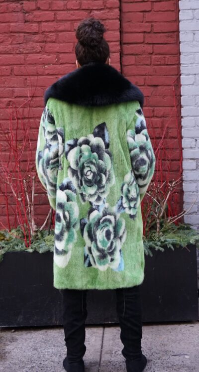 Knee-length green mink coat featuring large floral intarsia and a dark collar.
