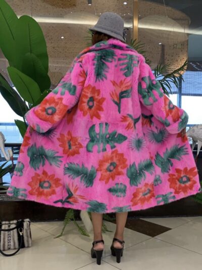 Full-length fuchsia mink coat with a floral botanical print, notched collar, and cuffed sleeves, worn.