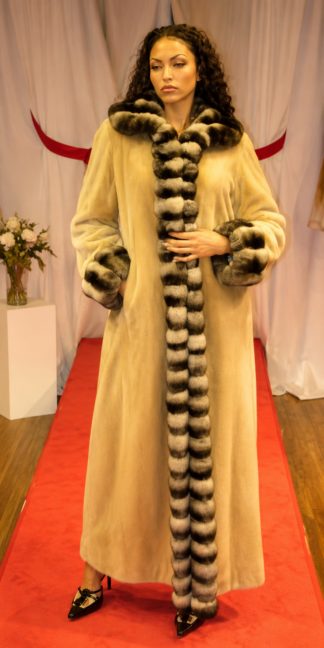 Full-length camel sheared mink coat featuring a voluminous chinchilla collar, front trim, and cuffs, worn standing.